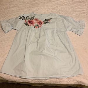 Light blue blouse with floral detail